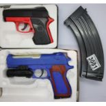 Two boxed airsoft pistols and an airsoft assault rifle magazine. P&P Group 1 (£14+VAT for the