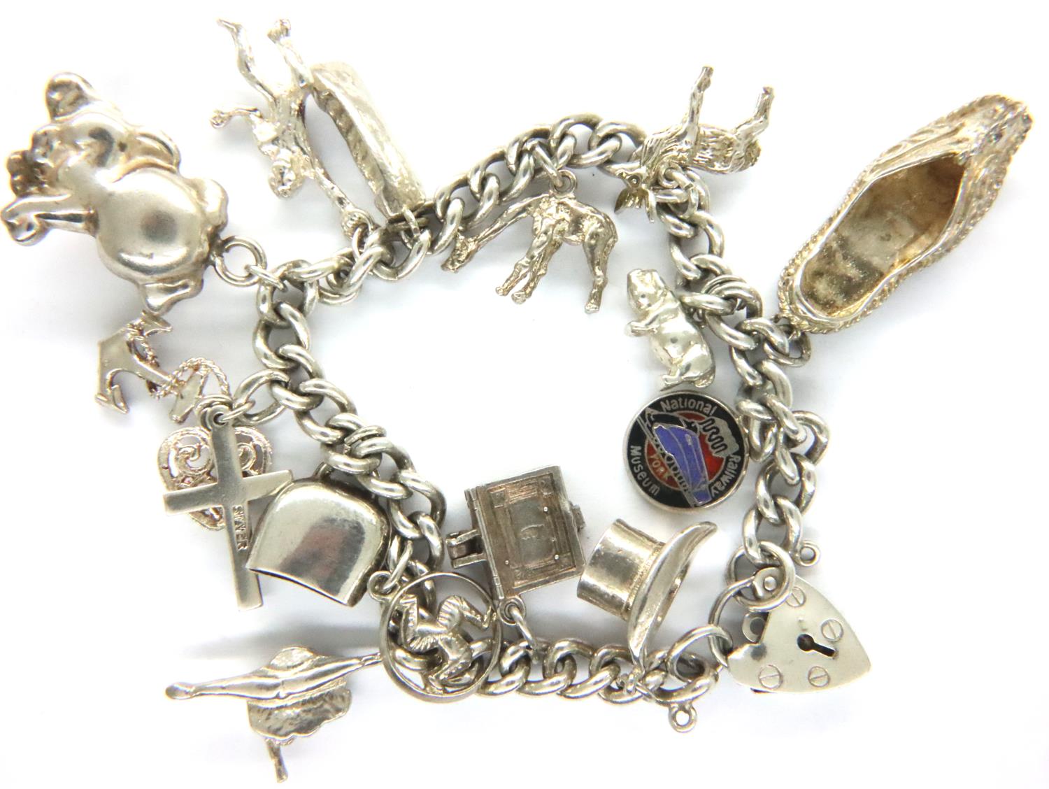 925 silver charm bracelet with fourteen charms, 49g. P&P Group 1 (£14+VAT for the first lot and £1+