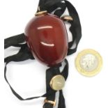 Large cherry amber pendant on a fabric strap with moonstone cabochons, amber 40 x 30 mm, combined