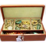 Leather jewellery box containing a large quantity of costume jewellery to include jade and silver