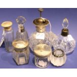 Cut glass silver topped atomiser, two scent bottles with silver collars, two glass jars with