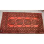 Red ground fringed woollen rug with four decorative panels. Not available for in-house P&P,
