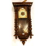 Large Vienna type chiming wall clock, with key and pendulum, lacking top pediment. Working at