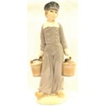 Lladro figurine of a Dutch farm boy with milk pitchers, H: 23 cm. P&P Group 2 (£18+VAT for the first
