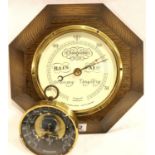 An oak wall barometer by Short and Mason London, 24 x 24 cm and a smaller example in brass. Not