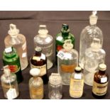 Twelve pharmacy bottles including two Poison bottles, all with stoppers. Not available for in-