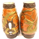 Pair of Chinese terracotta ground vases depicting four toed dragon and seated Mandarin, H: 18 cm.