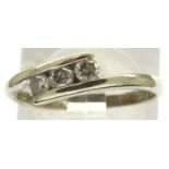 9ct white gold three stone (totalling 0.25cts) diamond crossover ring, size K, 1.8g. P&P Group 1 (£