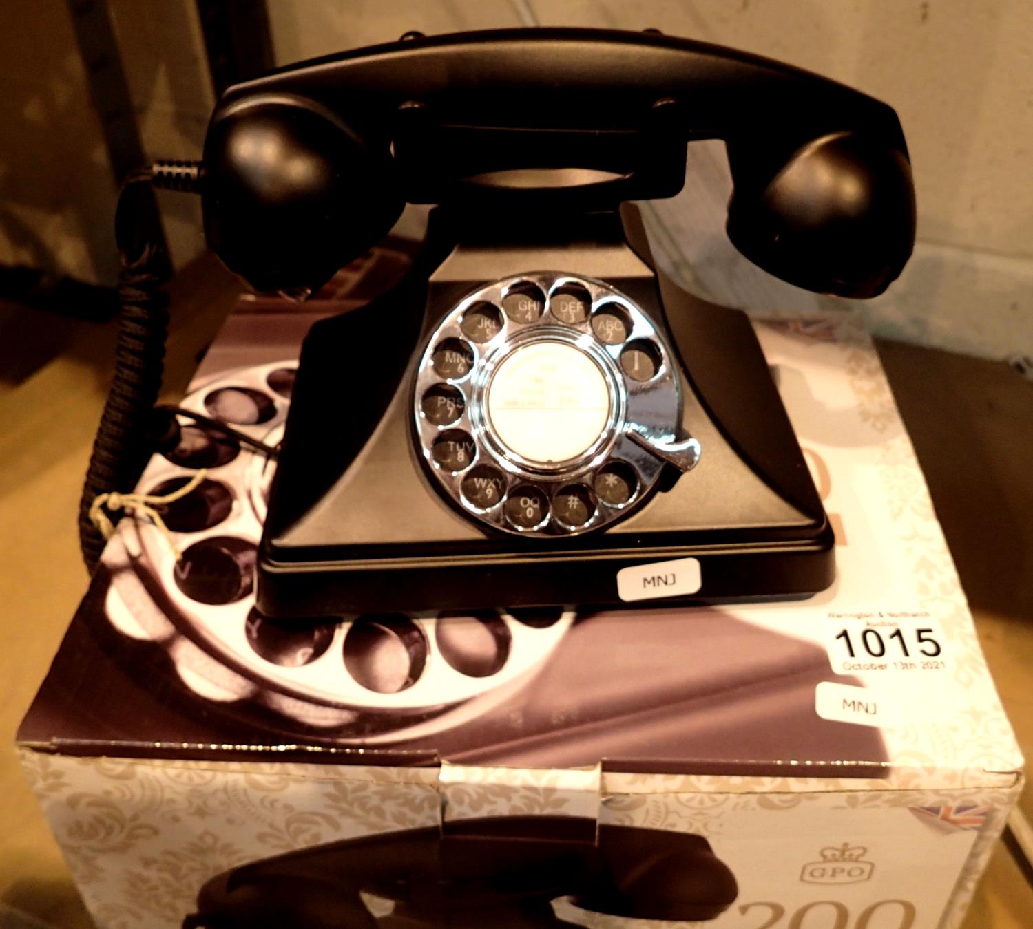 The GPO 200 rotary telephone has a metal base and handset; traditional cloth handset curly cord & is