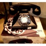 The GPO 200 rotary telephone has a metal base and handset; traditional cloth handset curly cord & is