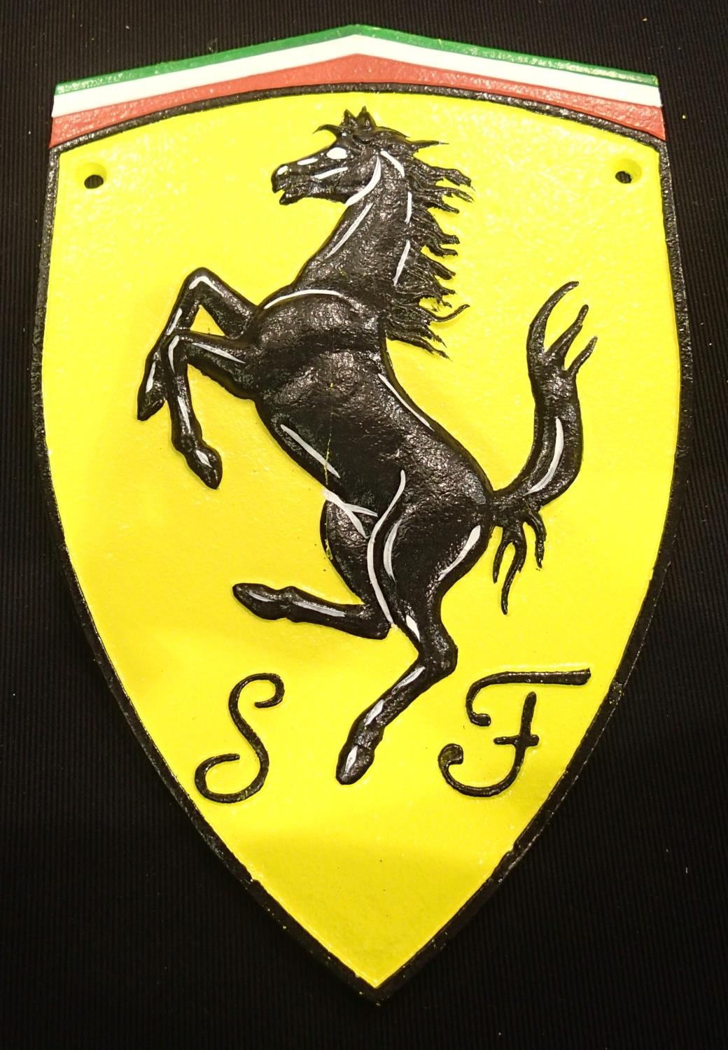 A cast iron Ferrari badge wall plaque, 20 x 30 cm. P&P Group 2 (£18+VAT for the first lot and £3+VAT