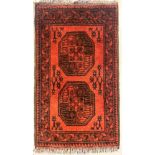 Red ground woollen fringed rug with two decorative panels, 60 x 90 cm. Not available for in-house