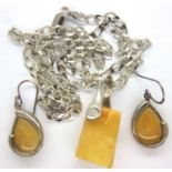 A silver butterscotch amber set pendant and necklace and earrings. Chain L: 60 cm, earring L: 30 mm.