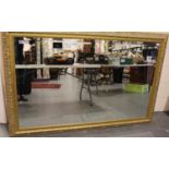 A substantial contemporary gilt framed rectangular mirror with bevelled glass, overall 170 x 110 cm.