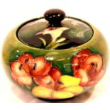 Moorcroft powder pot with matched cover in the Hibiscus pattern, paper label to base, D: 11 cm.