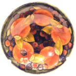 A Moorcroft shallow circular bowl in the Pomegranate pattern, D: 16 cm, signed to base. Rim slightly