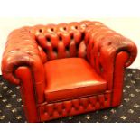 A 20th century red leather buttoned Chesterfield armchair, 105 x 90 x 70 cm H. Small tear to one