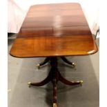 A large reproduction mahogany three pedestal dining table in the Georgian manner, having two