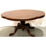 A Victorian burr walnut tilt top breakfast table with shaped top and carved quatrefoil base, 145 x