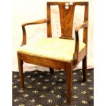 An early 19th century walnut framed elbow chair with upholstered drop in seat. Not available for