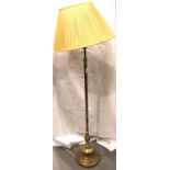 A 20th century brass standard lamp with weighted circular base, H: 128 cm. Not available for in-