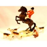 Beswick rearing Huntsman, four hounds and a fox figurine, H: 25 cm. No cracks, chips or visible