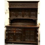 A substantial 19th century oak dresser in the Jacobean manner, with carved and panelled upstand