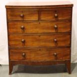 An early 19th century bow front mahogany chest of two short over three long drawers, raised on