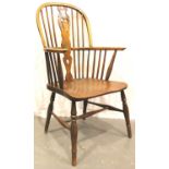 A late 18th century elm Windsor chair, stick back with turned supports and bobbin elbow supports.