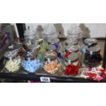 Quantity of small bows in jars, various colours. P&P Group 3 (£25+VAT for the first lot and £5+VAT