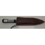 A vintage hunting knife with horn handle and stitched leather sheath. P&P Group 1 (£14+VAT for the