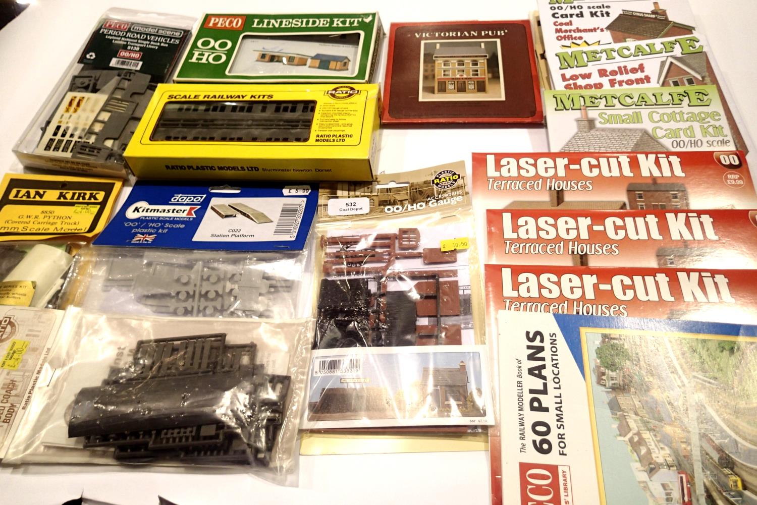 Collection of plastic and card OO scale railway related kits; bus, coach, cottage, shop, houses