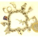 925 silver charm bracelet with ten charms, 43g. P&P Group 1 (£14+VAT for the first lot and £1+VAT