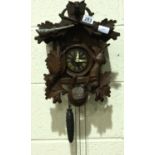 A 20th century Black Forest cuckoo clock, twin weight, the case carved with game, lacking