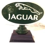 Green cast Jaguar sign on wooden base, 35 x 39 cm. P&P Group 3 (£25+VAT for the first lot and £5+VAT