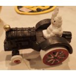 Cast iron Michelin man in tractor figurine, L: 10 cm. P&P Group 1 (£14+VAT for the first lot and £