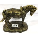 Bronzed cast metal saddled pony on base. P&P Group 2 (£18+VAT for the first lot and £3+VAT for
