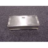 A SILVER CIGARETTE BOX WITH ENGINE TURNE
