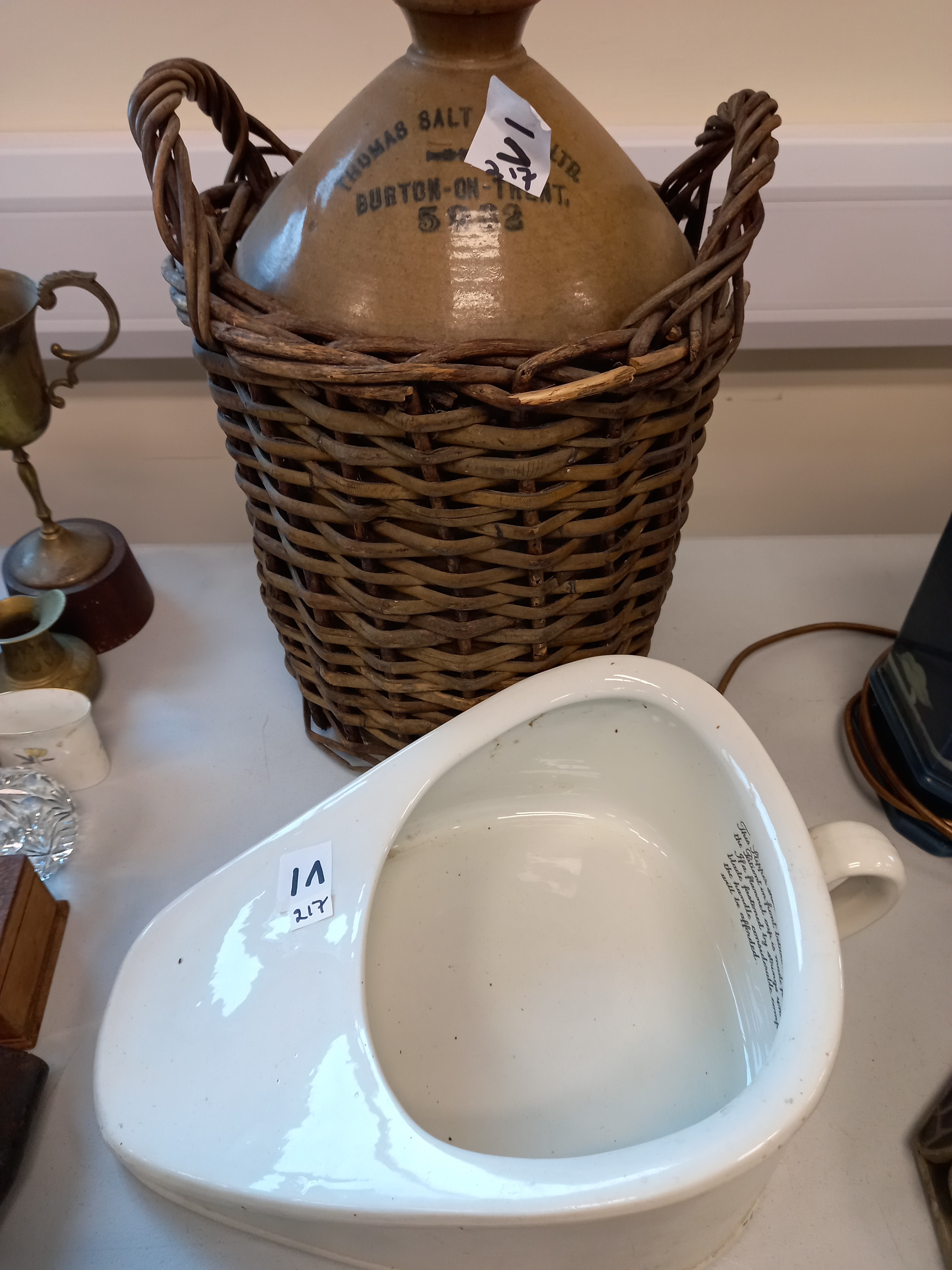 STONEWARE JUG IN WICKER BASKET