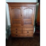 A late 18th/ early 19th century oak linen press with drawers beneath.