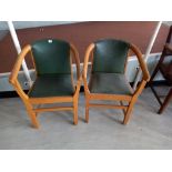 Two faux leather backed elbow chairs