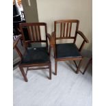 Two faux leather drop seat elbow chairs