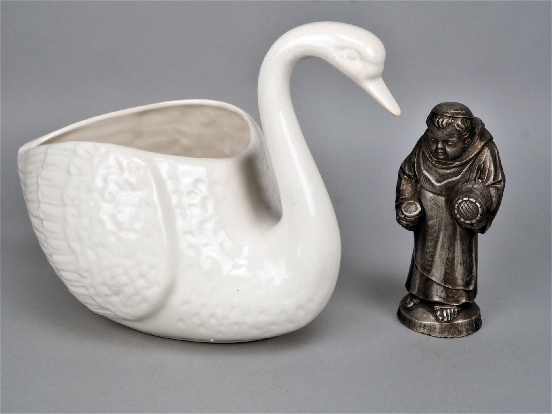 Two figures, swan and monk