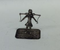 A small silver table toy in the form of a Dutchman