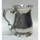 A large Georgian silver pint mug on spreading base