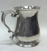 A large Georgian silver pint mug on spreading base