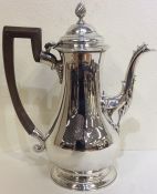 A tall George II silver coffee pot of baluster for