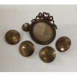 A set of four gilt buttons together with a small g