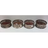 A set of four silver plated wine coasters. Est. £4