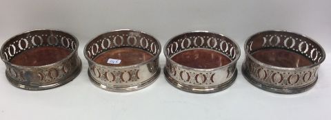 A set of four silver plated wine coasters. Est. £4